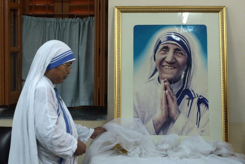  A nun of ¿the Missionaries of Charity decorates a picture of Mother Teresa prior to a special prayer service at Mother House in Kolkata on December 18, 2015. Mother Teresa, set to become a saint after the Vatican announced recognition of her second miracle, became a global symbol of compassion for her care of the sick and destitute. AFP PHOTO/ DIBYANGSHU SARKAREditoria: RELLocal: KolkataIndexador: DIBYANGSHU SARKARSecao: christianityFonte: AFPFotógrafo: STR