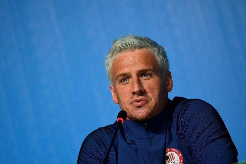 (FILES) This file photo taken on August 03, 2016 shows US swimmer Ryan Lochte holding a press conference in Rio de Janeiro, two days ahead of the opening ceremony of the Rio 2016 Olympic Games.Brazilian police have prevented two more U.S. swimmers from leaving the country after the Rio de Janeiro Olympics over the investigation of a robbery complaint by teammate Ryan Lochte. According to a report on O Globo Web site, swimmers Gunnar Bentz and Jack Conger were arrested and removed from their plane so Brazilian federal police could interview them Wednesday night. The U.S. Olympic Committee later confirmed their detention. / AFP PHOTO / MARTIN BUREAU