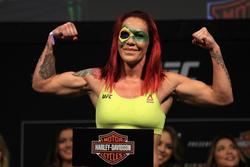 ANAHEIM, CA - JULY 28: Cris Cyborg of Brazil poses for fans on the scale during the UFC 214 weigh-in at Honda Center on July 28, 2017 in Anaheim, California. Cyborg will fight Tonya Evinger in the featherweight title bout on July 28, 2017 in Anaheim, California.   Sean M. Haffey/Getty Images/AFP