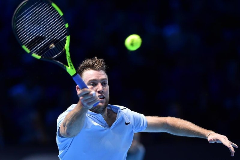 US player Jack Sock returns to Germanys Alexander Zverev during their mens singles round-robin match on day five of the ATP World Tour Finals tennis tournament at the O2 Arena in London on November 16 2017. / AFP PHOTO / Glyn KIRK