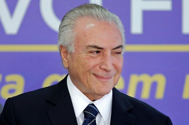 O presidente brasileiro Michel Temer gesticula durante o lançamento de um novo Fundo de Financiamento de Estudantes no Palácio do Planato em Brasília, em 6 de julho de 2017.Os advogados de Temer apresentaram sua defesa em 5 de julho contra acusações de corrupção que ameaçam expulsá-lo do cargo, negando alegações de que ele tirou um suborno de US $ 150.000 de uma empresa de embalagens de carne. / AFP PHOTO / SERGIO LIMA O presidente brasileiro Michel Temer gesticula durante o lançamento de um novo Fundo de Financiamento de Estudantes no Palácio do Planato em Brasília, em 6 de julho de 2017.Os advogados de Temer apresentaram sua defesa em 5 de julho contra acusações de corrupção que ameaçam expulsá-lo do cargo, negando alegações de que ele tirou um suborno de US $ 150.000 de uma empresa de embalagens de carne. / AFP PHOTO / SERGIO LIMA
