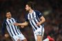 West Bromwich Albions English striker Jay Rodriguez (R) celebrates after scoring their first goal during the English FA Cup fourth round football match between Liverpool and West Bromwich Albion at Anfield in Liverpool, north west England on January 27, 2018. / AFP PHOTO / Paul ELLIS / RESTRICTED TO EDITORIAL USE. No use with unauthorized audio, video, data, fixture lists, club/league logos or live services. Online in-match use limited to 75 images, no video emulation. No use in betting, games or single club/league/player publications.  / 