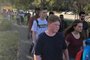 Students leave Marjory Stoneman Douglas High School in Parkland, Florida, a city about 50 miles (80 kilometers) north of Miami on February 14, 2018 following a school shooting.A gunman opened fire at the Florida high school, an incident that officials said caused numerous fatalities and left terrified students huddled in their classrooms, texting friends and family for help.The Broward County Sheriffs Office said a suspect was in custody. / AFP PHOTO / Michele Eve SANDBERG / The erroneous mention[s] appearing in the metadata of this photo by Michele Eve SANDBERG has been modified in AFP systems in the following manner: [Byline: Michele Eve SANDBERG] instead of [Eva Hambach]. Please immediately remove the erroneous mention from all your online services and delete it from your servers. If you have been authorized by AFP to distribute it to third parties, please ensure that the same actions are carried out by them. Failure to promptly comply with these instructions will entail liability on your part for any continued or post notification usage. Therefore we thank you very much for all your attention and prompt action. We are sorry for the inconvenience this notification may cause and remain at your disposal for any further information you may require.