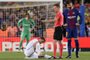 Real Madrids Portuguese forward Cristiano Ronaldo (L) sits on the field after resulting injured dbeside Spanish referee Hernandez Hernandez (C) and Barcelonas Spanish defender Gerard Pique uring the Spanish league football match between FC Barcelona and Real Madrid CF at the Camp Nou stadium in Barcelona on May 6, 2018. / AFP PHOTO / Josep LAGO