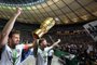Frankfurts Argentinian defender David Abraham (L) and Frankfurts German defender Marco Russ celebrate with the trophy after the German Cup DFB Pokal final football match FC Bayern Munich vs Eintracht Frankfurt at the Olympic Stadium in Berlin on May 19, 2018.  / AFP PHOTO / Tobias SCHWARZ / RESTRICTIONS: ACCORDING TO DFB RULES IMAGE SEQUENCES TO SIMULATE VIDEO IS NOT ALLOWED DURING MATCH TIME. MOBILE (MMS) USE IS NOT ALLOWED DURING AND FOR FURTHER TWO HOURS AFTER THE MATCH. == RESTRICTED TO EDITORIAL USE == FOR MORE INFORMATION CONTACT DFB DIRECTLY AT +49 69 67880 / 