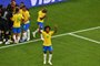 Brazils forward Willian gestures as Brazil players celebrate their second goal during the Russia 2018 World Cup round of 16 football match between Brazil and Mexico at the Samara Arena in Samara on July 2, 2018. / AFP PHOTO / SAEED KHAN / RESTRICTED TO EDITORIAL USE - NO MOBILE PUSH ALERTS/DOWNLOADS