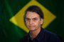  O candidato à Presidência da República pelo PSL, Jair Bolsonaro, vota no primeiro turno das Eleições 2018 na Vila Militar, em Marechal Hermes, na zona norte da cidade, neste domingo, 7.Brazils right-wing presidential candidate for the Social Liberal Party (PSL) Jair Bolsonaro walks in front of the Brazilian flag as he prepares to cast his vote during the general elections, in Rio de Janeiro, Brazil, on October 7, 2018.Polling stations opened in Brazil on Sunday for the most divisive presidential election in the country in years, with far-right lawmaker Jair Bolsonaro the clear favorite in the first round. About 147 million voters are eligible to cast ballots and choose who will rule the worlds eighth biggest economy. New federal and state legislatures will also be elected. / AFP PHOTO / Mauro PIMENTELEditoria: POLLocal: Rio de JaneiroIndexador: MAURO PIMENTELSecao: electionFonte: AFPFotógrafo: STF