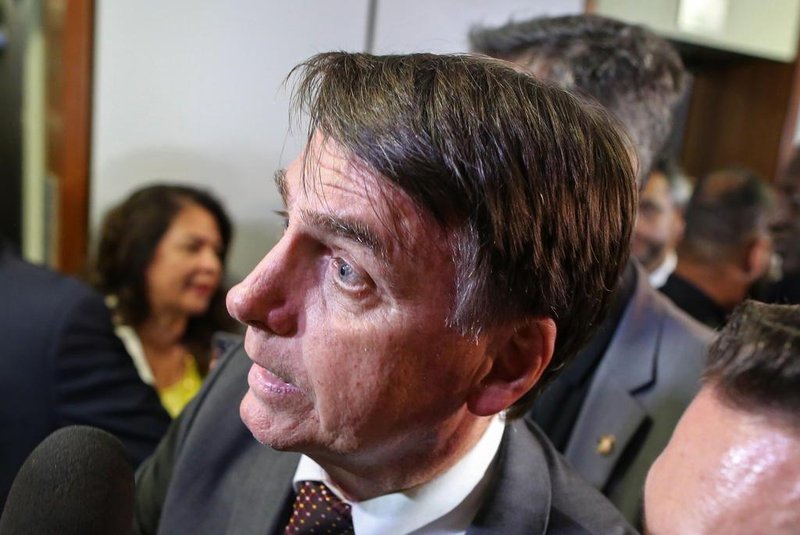 Brazils President-elect Jair Bolsonaro greets people during his visit to the Superior Court of Labour in Brasilia, on November 13, 2018. - Bolsonaro, who takes office on January 1, 2019, announced on Tuesday the appointment of reservist general Fernando Azevedo e Silva to the post of defense minister. (Photo by Sergio LIMA / AFP)