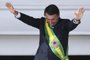  Brazils new President Jair Bolsonaro gestures after receiveing the presidential sash from outgoing Brazilian president Michel Temer (out of frame), at Planalto Palace in Brasilia on January 1, 2019. - Bolsonaro takes office with promises to radically change the path taken by Latin Americas biggest country by trashing decades of centre-left policies. (Photo by EVARISTO SA / AFP)Editoria: POLLocal: BrasíliaIndexador: EVARISTO SASecao: governmentFonte: AFPFotógrafo: STF