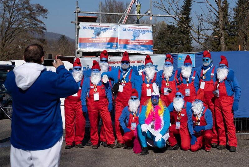 Participants pose for a picture during a gathering of people dressed as smurfs (small blue fictional creatures created by Belgian cartoonist Pierre Culliford)  to be counted as part of a world record attempt on February 16, 2019 in Lauchringen, Germany. (Photo by Constant FORME-BECHERAT / AFP)