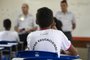 Students attend a class given by a police officer at the Education Center 07 of Ceilandia, near Brasilia which takes part in a pilot project of joint management between the Brazilian Secretariats of Education and Public Security, on February 12, 2019. - During his election campaign President Bolsonaro, a former paratrooper, promised to establish more of these state-run military secondary schools. By the end of the year, there should be around 40 education centers in which military police have been put in charge of discipline and administrative functions, while lessons are given by civilian teachers. (Photo by Sergio LIMA / AFP)