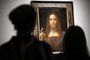 (FILES) In this file photo taken on October 24, 2017 Christies employees pose in front of a painting entitled Salvator Mundi by Italian polymath Leonardo da Vinci at a photocall at Christies auction house in central London ahead of its sale at Christies New York on November 15, 2017. - Later this year, the Louvre museum in Paris will host an exhibition grouping masterpieces of the great Italian painter Leonardo da Vinci to mark his death 500 years ago in France.The Salvator Mundi, sold at auction as a work by Leonardo for a record $450 million dollars in 2017, has not been displayed in public since, as doubts swirl about its ownership, whereabouts and authenticity. (Photo by Tolga Akmen / AFP) / RESTRICTED TO EDITORIAL USE - MANDATORY MENTION OF THE ARTIST UPON PUBLICATION - TO ILLUSTRATE THE EVENT AS SPECIFIED IN THE CAPTION