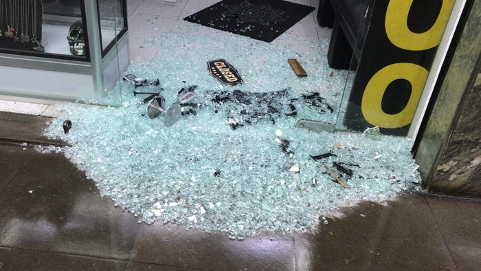 Criminosos quebraram porta de vidro de uma das lojas