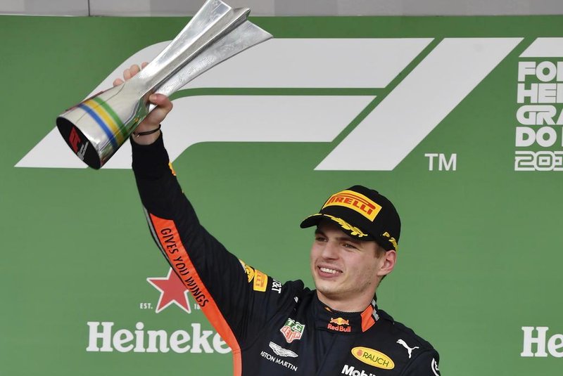 Red Bulls Dutch driver Max Verstappen celebrates at the podium after winning the F1 Brazil Grand Prix, at the Interlagos racetrack in Sao Paulo, Brazil on November 17, 2019. (Photo by NELSON ALMEIDA / AFP)