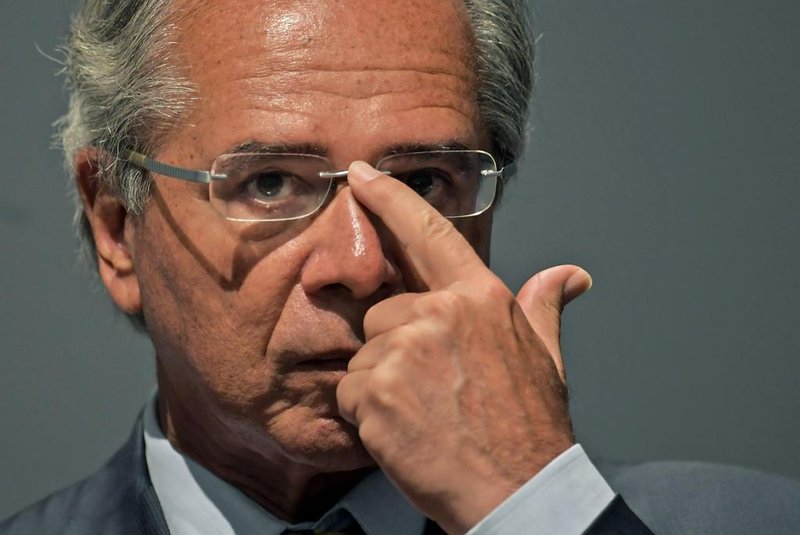 The new Brazilian Economy Minister, Paulo Guedes takes office during a ceremony in Brasilia, on January 02, 2019. - Brazls President Jair Bolsonaro has appointed a free-marketeer, Paulo Guedes, as economy minister to push through reforms to bring down Brazils swelling debt, mainly through privatizations, tax changes and encouraging foreign investment. (Photo by CARL DE SOUZA / AFP)<!-- NICAID(13898707) -->