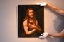 An attendant poses holding the recently discovered Madeleine penitente, a painting by Salai, Leonardo da Vincis closest collaborator, at The Articurial Auction House in Paris on November 17, 2020, ahead of its scheduled auction on November 18. (Photo by Alain JOCARD / AFP)<!-- NICAID(14647103) -->