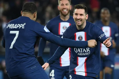 Paris Saint-Germain's Argentine forward Lionel Messi (R) celebrates with Paris Saint-Germain's French forward Kylian Mbappe (L) after scoring a goal during the French L1 football match between Paris Saint-Germain (PSG) and FC Nantes at The Parc des Princes Stadium in Paris on March 4, 2023. (Photo by FRANCK FIFE / AFP)<!-- NICAID(15368676) -->