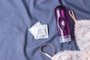 an intimate lubricant and a female bra against the background of the sheet. condoms. intimate gel.Fonte: 202291806<!-- NICAID(14997422) -->