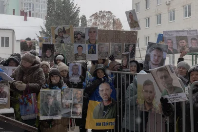People hold portraits of their missing or captured relatives and friends as they wait for the arrival of released Ukrainian prisoners of war (POW) in the Chernihiv region, at an undisclosed location on February 5, 2026, amid the Russian invasion of Ukraine. Ukraine and Russia have conducted their first prisoner exchange in months, each releasing at least 157 people, both countries said on February 5, 2026, amid US-brokered talks in Abu Dhabi aimed at ending the war. The two sides have in the past conducted several rounds of prisoner swaps, one of the rare areas of direct cooperation between Ukraine and Russia amid the four-year war, but last month Kyiv accused Moscow of halting the exchanges. (Photo by Roman PILIPEY / AFP)<!-- NICAID(16219792) -->