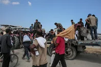 Displaced Palestinians sit on a trailer with bags of humanitarian aid they received at a distribution centre run by the US and Israeli-backed Gaza Humanitarian Foundation (GHF) at the so-called "Netzarim corridor" in the central Gaza Strip on August 4, 2025. Aid agencies have warned that Gaza's population is facing a catastrophic famine, triggered by Israeli restrictions on aid. (Photo by AFP)<!-- NICAID(16095288) -->