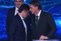 Brazilian President and presidential candidate Jair Bolsonaro (R) speaks with former Minister of Justice Sergio Moro (L) during a televised presidential debate in Sao Paulo, Brazil, on October 16, 2022. - President Jair Bolsonaro and former President Luiz Inácio Lula da Silva face each other this Sunday night in the first face-to-face debate, in which they will try to take advantage 14 days before the second round of the presidential elections in Brazil. (Photo by NELSON ALMEIDA / AFP)Editoria: POLLocal: Sao PauloIndexador: NELSON ALMEIDASecao: electionFonte: AFPFotógrafo: STF<!-- NICAID(15237027) -->