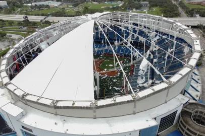 A drone image shows the dome of Tropicana Field which has been torn open due to Hurricane Milton in St. Petersburg, Florida, on October 10, 2024. At least four people were confirmed killed as a result of two tornadoes triggered by Hurricane Milton on the east coast of the US state of Florida, local authorities said Thursday. (Photo by Bryan R. SMITH / AFP)<!-- NICAID(15887885) -->