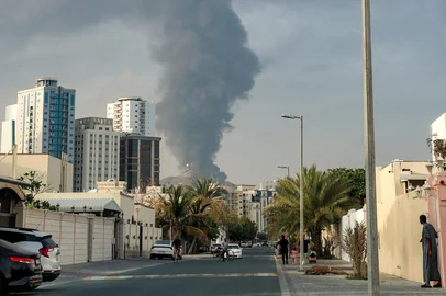 FADEL SENNA / AFP People watch from a street as a tall smoke plume billows following an explosion in the Fujairah industrial zone on March 3, 2026. Iran's strikes on Gulf neighbours since February 28, following the US-Israeli attack, forced the UAE to shut its airspace, blindsiding travellers who thought they were headed to one of the region's safest holiday destinations. (Photo by Fadel SENNA / AFP)<!-- NICAID(16237375) -->