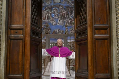 This photo taken and handout on May 7, 2025 by The Vatican Media shows Diego Giovanni Ravelli,  Master of Pontifical Liturgical Celebrations, closing the doors of the Sistine chapel at the start of the conclave to elect a new Pope in the Sistine chapel in The Vatican. (Photo by Handout / VATICAN MEDIA / AFP) / RESTRICTED TO EDITORIAL USE - MANDATORY CREDIT "AFP PHOTO / VATICAN MEDIA" - NO MARKETING - NO ADVERTISING CAMPAIGNS - DISTRIBUTED AS A SERVICE TO CLIENTS<!-- NICAID(16032147) -->