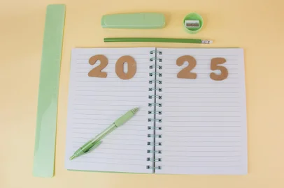 View of office desk with notepad with goals for 2025 and business plan for new year showing list of strategies and space for future decisions<!-- NICAID(15945560) -->