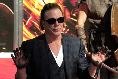 Actors Mickey Rourke holds up his hands after pressing them in cement at his Hand e Footprint ceremony in front of Grauman's Chinese Theater in Hollywood, California October 31, 2011.  Rourke stars in the upcoming feature film Immortals.  AFP PHOTO / Robyn Beck<!-- NICAID(7636006) -->