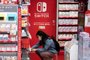 A customer browses the gaming section of Nintendo products in a shop in Tokyo on May 6, 2021. (Photo by Philip FONG / AFP)<!-- NICAID(14775635) -->