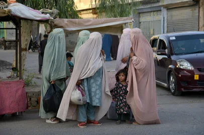 Afghan burqa-clad women walk along a road in Arghandab district of Kandahar Province on September 10, 2025. (Photo by Sanaullah SEIAM / AFP)<!-- NICAID(16128578) -->