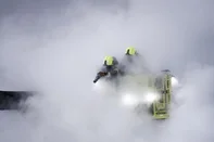 Firefighters douses flames of a fire that broke out at a substation supplying power to Heathrow Airport in Hayes, west London on March 21, 2025. Britain's Heathrow airport, Europe's busiest, was shut down early on March 21 for 24 hours after a major fire at an electricity substation cut power to the sprawling facility west of London, officials said. (Photo by BENJAMIN CREMEL / AFP)<!-- NICAID(16000311) -->