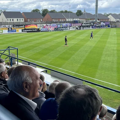 Crowds look on including former Glenavon player John Duggan (2L), as a football match takes place in Lurgan, Northern Ireland on July 6, 2025. A European football tie cancelled due to Cold War-era tensions was finally completed in Northern Ireland on July 6, 2025, 65 years on from its original schedule in 1960. Glenavon FC hosted FC Erzgebirge Aue known as Wismut Karl-Marx-Stadt during the communist era, in Lurgan 25 miles (40 kilometres) west of Belfast. (Photo by Peter MURPHY / AFP)Editoria: SPOLocal: LurganIndexador: PETER MURPHYSecao: soccerFonte: AFPFotógrafo: STR<!-- NICAID(16074730) -->