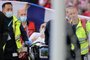 Denmark's midfielder Christian Eriksen (C) is evacuated after collapsing on the pitch during the UEFA EURO 2020 Group B football match between Denmark and Finland at the Parken Stadium in Copenhagen on June 12, 2021. (Photo by Friedemann Vogel / various sources / AFP)<!-- NICAID(14807687) -->