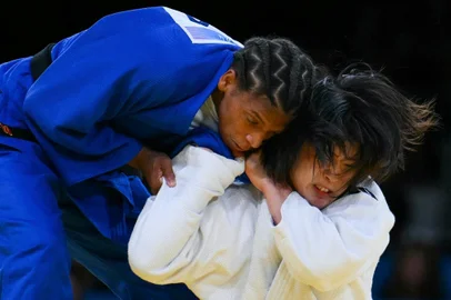 South Korea's Huh Mi-mi and Brazil's Rafaela Silva (Blue) compete in the judo women's -57kg semi-final bout of the Paris 2024 Olympic Games at the Champ-de-Mars Arena, in Paris on July 29, 2024.Luis ROBAYO / AFP