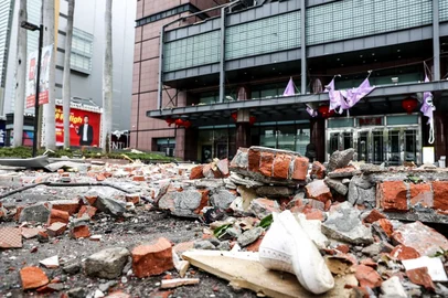Rubbles litter the entrance after an explosion at the Shin Kong Mitsukoshi department store in Taichung on February 13, 2025. A suspected gas explosion in a Taiwan department store killed four people and left another "without vital signs", authorities said, with videos showing large pieces of debris raining on the street. (Photo by I-Hwa Cheng / AFP)<!-- NICAID(15975365) -->