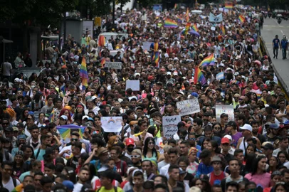 Members of the Lesbian, Gay, Bisexual and Transgender (LGBT+) community take part the annual Pride Parade in Caracas on July 3, 2022. (Photo by Federico PARRA / AFP)<!-- NICAID(15139259) -->