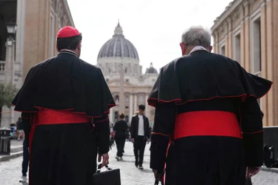 Canadian Cardinal Thomas Christopher Collins (R) and Canadian cardinal Francis Leo walk on Via della Conciliazione street near The Vatican with St Peter's Basilica in the background in Rome on May 5, 2025.
