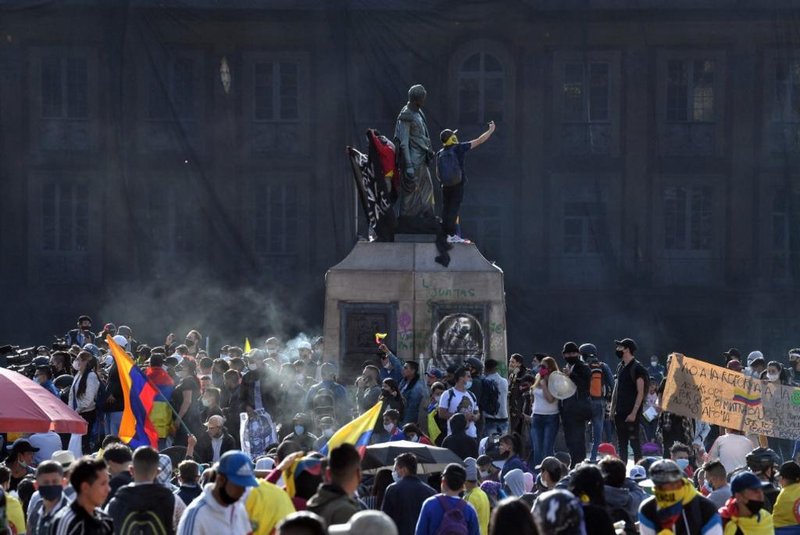 People protest against the government of Colombian President Ivan Duque, at Bolivar square in Bogota on May 12, 2021. - At least 42 people have been killed in near-daily protests against the Colombian government since April 28, the country's human rights ombudsman said Tuesday. The protests, initially against a proposed tax reform, soon morphed into a broader demonstration of anti-government sentiment in a country battling ongoing violence and economic hardship made worse by the coronavirus epidemic. (Photo by JUAN BARRETO / AFP)<!-- NICAID(14782209) -->