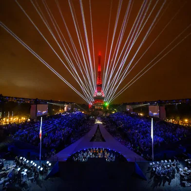 Overview of the Trocadero venue, with the Eiffel Tower looming in the background and lasers lighting up the sky, during the opening ceremony of the Paris 2024 Olympic Games on July 26, 2024 (Photo by François-Xavier MARIT / AFP)<!-- NICAID(15824224) -->