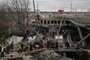 People cross a destroyed bridge as they evacuate the city of Irpin, northwest of Kyiv, during heavy shelling and bombing on March 5, 2022, 10 days after Russia launched a military in vasion on Ukraine. (Photo by Aris Messinis / AFP)<!-- NICAID(15036779) -->