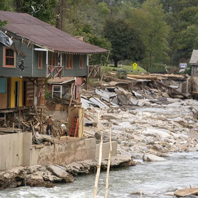 BAT CAVE, NORTH CAROLINA - OCTOBER 1: Destroyed houses and buildings along the Broad River in the aftermath of Hurricane Helene on October 1, 2024 in Bat Cave, North Carolina. The death toll has topped 140 people across the southeastern U.S. due to the storm, according to published reports, which made landfall as a category 4 storm on Thursday. Millions are without power and the federal government has declared major disasters in areas of North Carolina, Florida, South Carolina, Tennessee, Georgia, Virginia and Alabama, freeing up federal emergency management money and resources for those states, according to the reports.   Sean Rayford/Getty Images/AFP (Photo by Sean Rayford / GETTY IMAGES NORTH AMERICA / Getty Images via AFP)<!-- NICAID(15880519) -->
