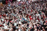 England supporters celebrate after the team's first goal as they watch a live broadcast of the 2026 World Cup semifinal football match between England and Argentina, at Boxpark Wembley in London on July 15, 2026. (Photo by Brook Mitchell / AFP)<!-- NICAID(16328970) -->