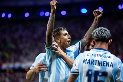 Racing's midfielder #32 Agustin Almendra celebrates with teammates after scoring during the Copa Libertadores group stage first round football match between Brazil's Fortaleza and Argentina's Racing Club at the Arena Castelao stadium in Fortaleza, Brazil, on April 1, 2025. (Photo by Thiago Gadelha / AFP)<!-- NICAID(16008243) -->