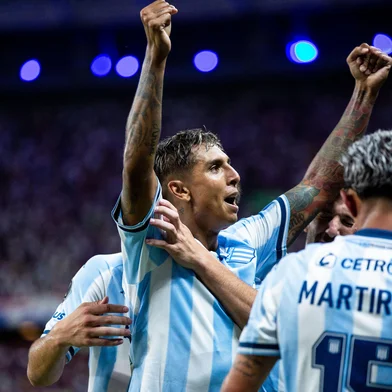 Racing's midfielder #32 Agustin Almendra celebrates with teammates after scoring during the Copa Libertadores group stage first round football match between Brazil's Fortaleza and Argentina's Racing Club at the Arena Castelao stadium in Fortaleza, Brazil, on April 1, 2025. (Photo by Thiago Gadelha / AFP)<!-- NICAID(16008243) -->