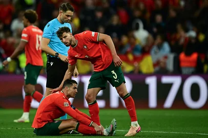 Portugal's defender #03 Ruben Dias (R) consoles Portugal's forward #07 Cristiano Ronaldo after sustaining an injury during the UEFA Nations League final football match between Portugal and Spain in Munich, southern  on June 8, 2025. (Photo by Tobias SCHWARZ / AFP)<!-- NICAID(16055296) -->