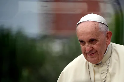 TOPSHOTSPope Francis arrives with his popemobile at the Catholic University in Tirana, on September 21, 2014.  The pontiff travels to Albania on September 21 for a packed one-day visit that will spotlight the country as a model of inter-religious harmony, amid turmoil in the Middle East and rising intolerance in Europe.                              AFP PHOTO / FILIPPO MONTEFORTE<!-- NICAID(10856693) -->