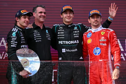 WILLIAM WEST / AFP First-placed Mercedes' British driver George Russell (2nd R) celebrates on the podium next to second-placed Mercedes' Italian driver Kimi Antonelli (L) with Hywel Thomas (2nd L), managing director of Mercedes AMG High Performance Powertrains, and third-placed Ferrari's Monegasque driver Charles Leclerc (R) after the Formula One Australian Grand Prix at the Albert Park Circuit in Melbourne on March 8, 2026. (Photo by WILLIAM WEST / AFP) / -- IMAGE RESTRICTED TO EDITORIAL USE - STRICTLY NO COMMERCIAL USE --<!-- NICAID(16242330) -->