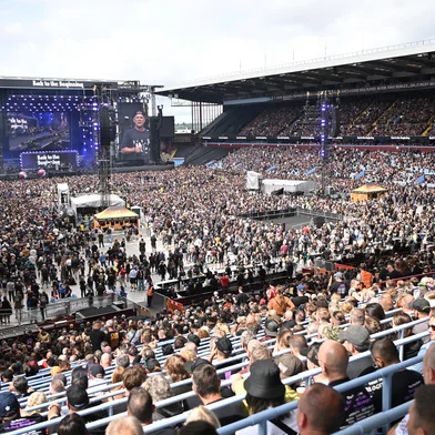 The Villa Park crowd watch support acts, during British rock band Black Sabbath's "Back to The Beginning" concert, Ozzy Osbourne's final ever gig as Black Sabbath's frontman at Villa Park in Birmingham, central England on July 5, 2025. Osbourne, who revealed in 2020 that he has Parkinson's disease, will join Tony Iommi, Geezer Butler and Bill Ward for the all-day "Back To The Beginning" show in Birmingham, central England, where the heavy metal giants formed in 1968. (Photo by ANDY BUCHANAN / AFP)<!-- NICAID(16074157) -->
